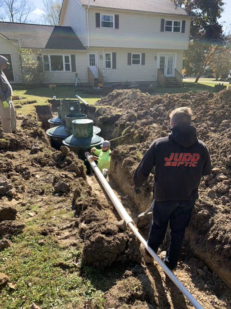 Judd Septic Tank Cleaning workers install and inspect a home septic system, showing their maintenance expertise.